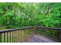 A wooden deck offers views of lush greenery and fenced yard at 6927 Gallant Se Cir # 11, Mableton, GA 30126