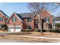 Charming brick home featuring a manicured lawn, attached garage, and complemented by tasteful landscaping at 1107 Carroll Ct, Norcross, GA 30071