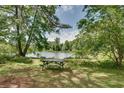 Scenic view of a lake and picnic table, perfect for outdoor enjoyment and relaxation at 4621 Lakeshore Dr, Pine Lake, GA 30072