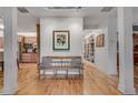 Open-concept foyer with hardwood floors and accent bench that flows into the kitchen at 4621 Lakeshore Dr, Pine Lake, GA 30072