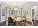 Bright dining room features hardwood floors, large windows, and modern light fixture at 47 Oakridge Se Ave, Atlanta, GA 30317