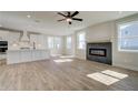Open-concept living space showcasing a modern fireplace, hardwood floors, and abundant natural light at 4735 Montane St, Cumming, GA 30028