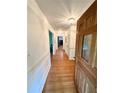 Inviting entryway with hardwood floors, white wainscoting and decorative light fixtures at 1333 Council Bluff Ne Dr, Atlanta, GA 30345