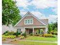 Charming, brick home featuring manicured landscaping, a walkway, and a welcoming front porch at 2727 Bearcreek Pl, Buford, GA 30519