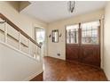 Inviting foyer featuring parquet floors, stairs, and a unique double-door entry at 4354 Revere Cir, Marietta, GA 30062