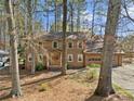 Traditional two-story home with a brown facade, covered entry, and attached two-car garage at 4354 Revere Cir, Marietta, GA 30062