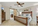 Bedroom featuring wood-slat sliding door, ceiling fan, neutral walls, and carpeted floors at 3605 Hickory Se Cir, Smyrna, GA 30080