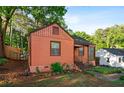 This single-story home features a well-maintained yard, mature trees and a bright exterior at 1776 Fairway Hill Se Dr, Atlanta, GA 30317
