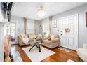 Bright living room with hardwood floors, a decorative fireplace, and neutral furnishings at 1776 Fairway Hill Se Dr, Atlanta, GA 30317