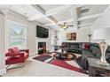 Spacious living room featuring a fireplace, coffered ceilings, and a comfortable leather sectional sofa at 3024 Bridgehaven Ct, Snellville, GA 30039