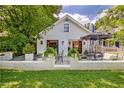 A beautiful white cottage-style home with a cozy outdoor seating area and manicured lawn at 439 Atlanta Se Ave, Atlanta, GA 30315