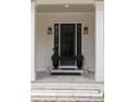 A stylish front door framed by white columns and manicured greenery at 633 Channing Nw Dr, Atlanta, GA 30318