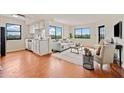 Spacious open-concept living area, with hardwood floors, large windows, and comfortable seating at 795 Hammond Dr # 808, Sandy Springs, GA 30328