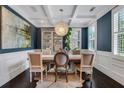 Dining room with wainscoting, modern light fixture, and bright windows at 3467 Brookleigh Ne Ln, Atlanta, GA 30319
