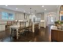 Bright, open kitchen features white cabinetry, granite countertops, a center island and stainless steel appliances at 3467 Brookleigh Ne Ln, Atlanta, GA 30319