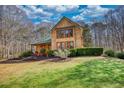View of a house with a well-manicured lawn and mature trees, creating a serene and inviting outdoor space at 5642 N Highway 212, Covington, GA 30016