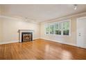 Bright and airy living room with a fireplace, large windows, and hardwood floors at 22 Peachtree Hills Ne Ave, Atlanta, GA 30305