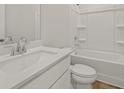 Cozy white bathroom with modern fixtures, a vanity, a toilet, and a shower-tub combo at 2625 Mourning Dove Dr (Lot 47), Grayson, GA 30017