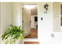 Inviting entryway featuring an open door view to the living room with hardwood floors and a glimpse of the fireplace at 495 Hascall Nw Rd, Atlanta, GA 30309