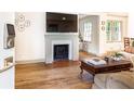 Bright living room with a cozy fireplace, hardwood floors, and stylish décor and furnishings at 495 Hascall Nw Rd, Atlanta, GA 30309