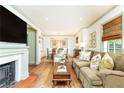 Open-concept living room featuring a fireplace, dining area, and comfortable seating with floral pillows at 495 Hascall Nw Rd, Atlanta, GA 30309