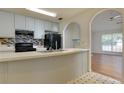 Kitchen with stainless steel appliances and breakfast bar, connects to a sunny living area at 6715 Biscayne Blvd, Rex, GA 30273