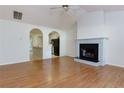 Bright living room with hardwood floors and a cozy fireplace, open to the kitchen area at 6715 Biscayne Blvd, Rex, GA 30273