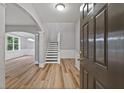 Welcoming foyer featuring hardwood floors, fresh paint, a staircase and arched doorways at 950 Mill Creek Ave, Canton, GA 30115