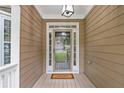 Covered front porch with a glass door entrance and 'Welcome' doormat at 950 Mill Creek Ave, Canton, GA 30115