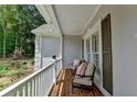 Cozy balcony with brick flooring, seating, and natural light, perfect for relaxation at 9585 Fenbrook Ct, Johns Creek, GA 30022