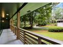 A covered front porch with wood railing overlooks a meticulously landscaped front yard at 2356 Sherbrooke Ne Dr, Atlanta, GA 30345