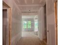 The home's unfinished hallway leads into a room with abundant natural light at 2759 S Waterworks Rd, Buford, GA 30518