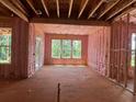 Unfinished interior room with exposed ceiling beams, framed doorways, and large windows, promising natural light at 2759 S Waterworks Rd, Buford, GA 30518