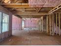 Exposed studs and pink insulation fill the unfinished interior, offering a blank canvas for your dream home design at 2759 S Waterworks Rd, Buford, GA 30518