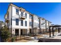 Beautiful townhouse exterior with brick accents, balconies, and manicured landscaping on a sunny day at 348 Olmstead Way # 30, Alpharetta, GA 30022