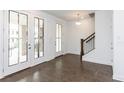 Bright foyer showcasing hardwood floors, staircase, and front entry with glass-paneled sidelights and doors at 348 Olmstead Way # 30, Alpharetta, GA 30022