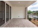Charming brick patio with view of the street, enclosed by a partial brick and paneled wall at 348 Olmstead Way # 30, Alpharetta, GA 30022