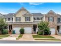 Inviting townhomes with garages and covered entries, showcasing a blend of brick and siding at 442 Colonial Walk, Woodstock, GA 30189
