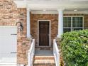 Close-up of the front door with white columns and brick facade at 6018 Oakdale Se Rd, Mableton, GA 30126