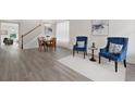 Bright living area with hardwood floors, dining table, and accent chairs at 6018 Oakdale Se Rd, Mableton, GA 30126