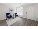 Cozy living room showcasing neutral walls, hardwood floors, and accent chairs at 6018 Oakdale Se Rd, Mableton, GA 30126
