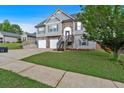 Two-story home with a well-manicured lawn and convenient two-car garage, perfect for Gathering living at 218 Depot Ln, Dallas, GA 30157