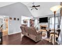 Cozy living room with hardwood floors, fireplace, and vaulted ceiling with ceiling fan at 218 Depot Ln, Dallas, GA 30157