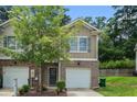 Charming townhome with brick accents, attached garage and inviting front yard at 3271 Pennington Dr, Stonecrest, GA 30038