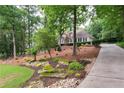 Well-maintained home with a long driveway, landscaped gardens and mature trees at 3750 Cannonwolde Dr, Snellville, GA 30039