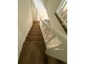 Carpeted staircase with white rails in a home with lots of natural light at 4485 Golf Vista Cir, Decatur, GA 30035