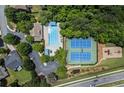 Aerial view of community pool, tennis courts, playground, and surrounding greenery at 6175 Beaver Crossing Dr, Cumming, GA 30040