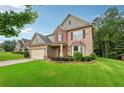 Beautiful two-story home with a well-maintained lawn, mature trees, and a charming facade at 1610 Kenilworth Se Ln, Conyers, GA 30013