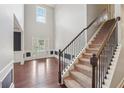 Grand foyer with soaring ceilings, elegant staircase, and natural light streaming through the front door at 1610 Kenilworth Se Ln, Conyers, GA 30013