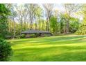 Lush front lawn surrounds this cozy home with mature trees, shrubs, and meticulously maintained landscaping at 1850 Winchester Trl, Brookhaven, GA 30341